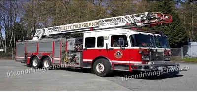 Surrey Fire Service ladder truck parked in a yard