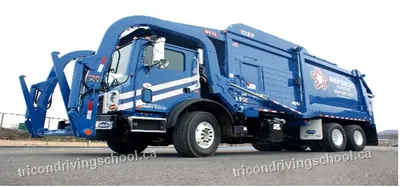 Blue front-loader garbage truck with lifting forks raised