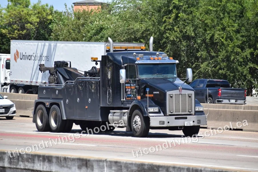 Heavy-duty tow truck driving on a highway