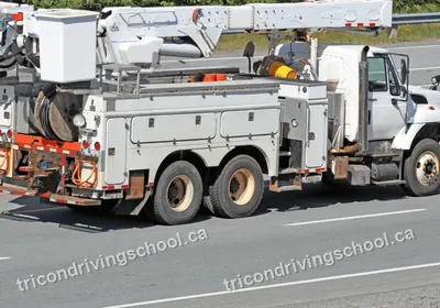 Power line utility service truck with an aerial boom