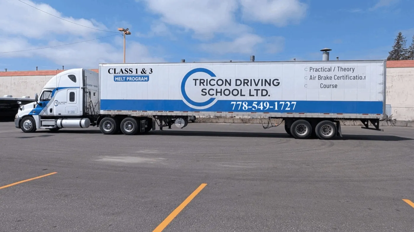 A Tricon Driving School truck and trailer, painted with Class 1 & 3 MELT program and air brake certification course details